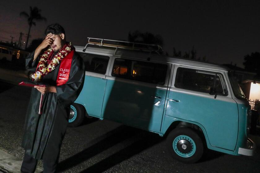 Baldwin Park, CA, Thursday, June 3, 2021 - Cesar Martinez hangs composes himself while having photos taken in front of a vintage VW fan he helped his brother restore. (Robert Gauthier/Los Angeles Times)