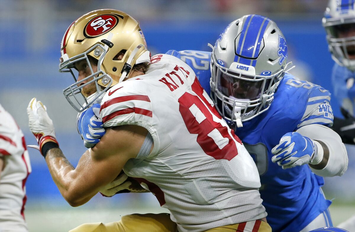 Detroit Lions defensive tackle Kevin Strong tackles San Francisco 49ers tight end George Kittle.
