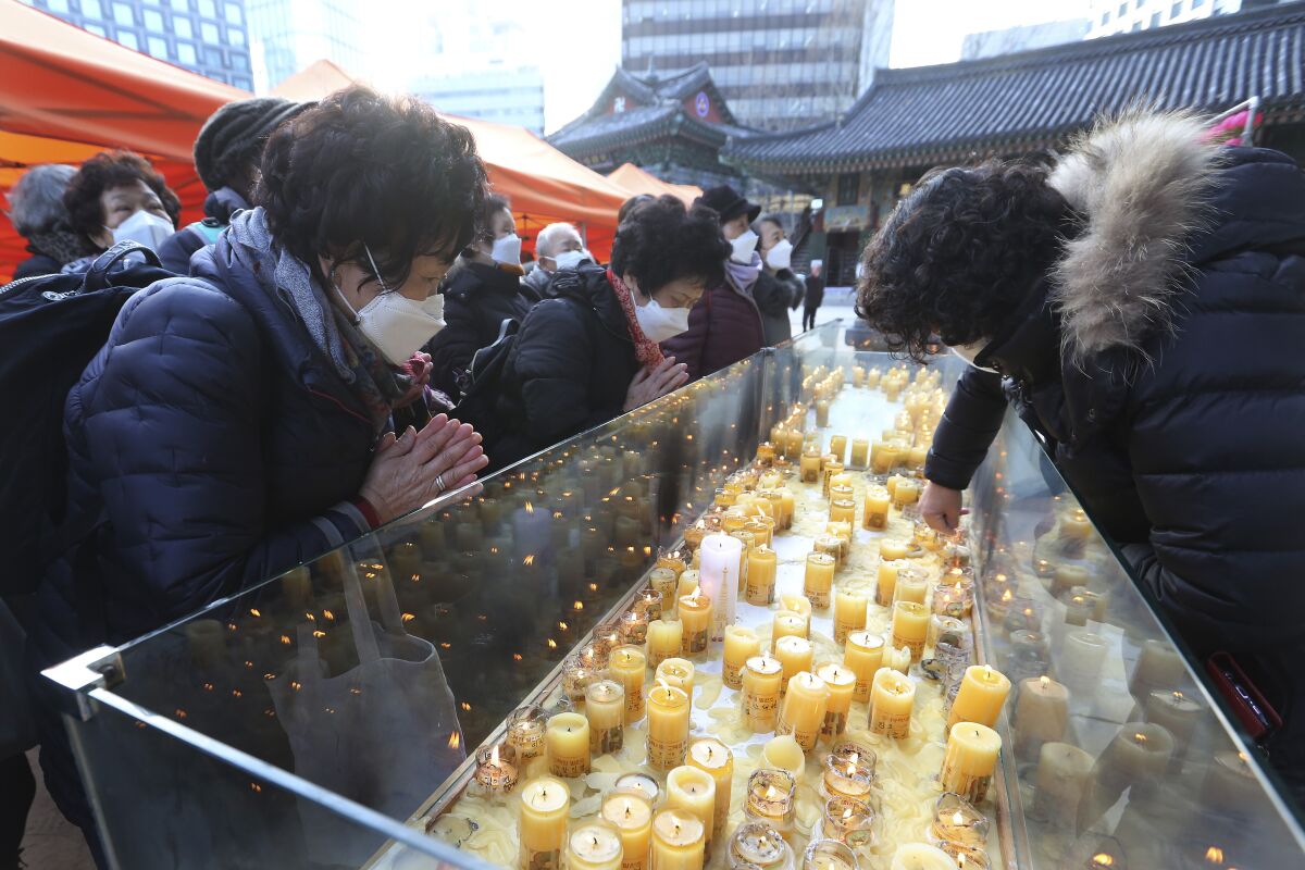 At a temple in Seoul, parents pray for their children on the eve of South Korea's national college entrance exam. 