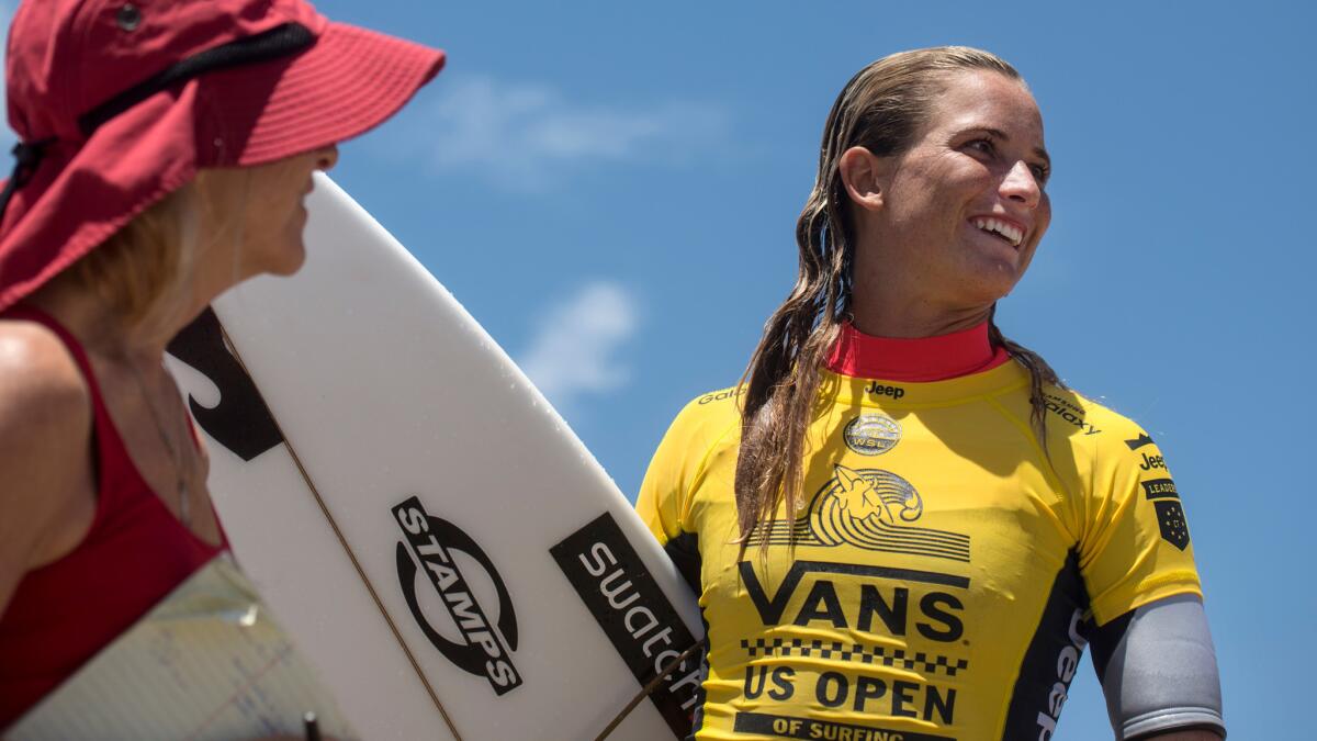 Courtney Conlogue greets media and fans after placing second in her heat during the first round of the US Open of Surfing in Huntington Beach.
