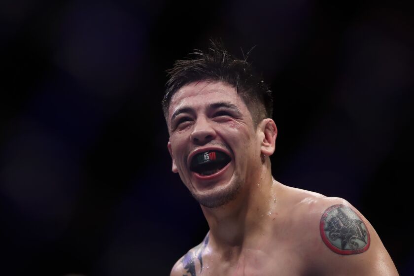 Mexico's Brandon Moreno celebrates victory over Brazil's Gilbert Durinho in a flyweight title bout at the UFC 283 mixed martial arts event in Rio de Janeiro early Sunday, Jan. 22, 2023. (AP Photo/Bruna Prado)