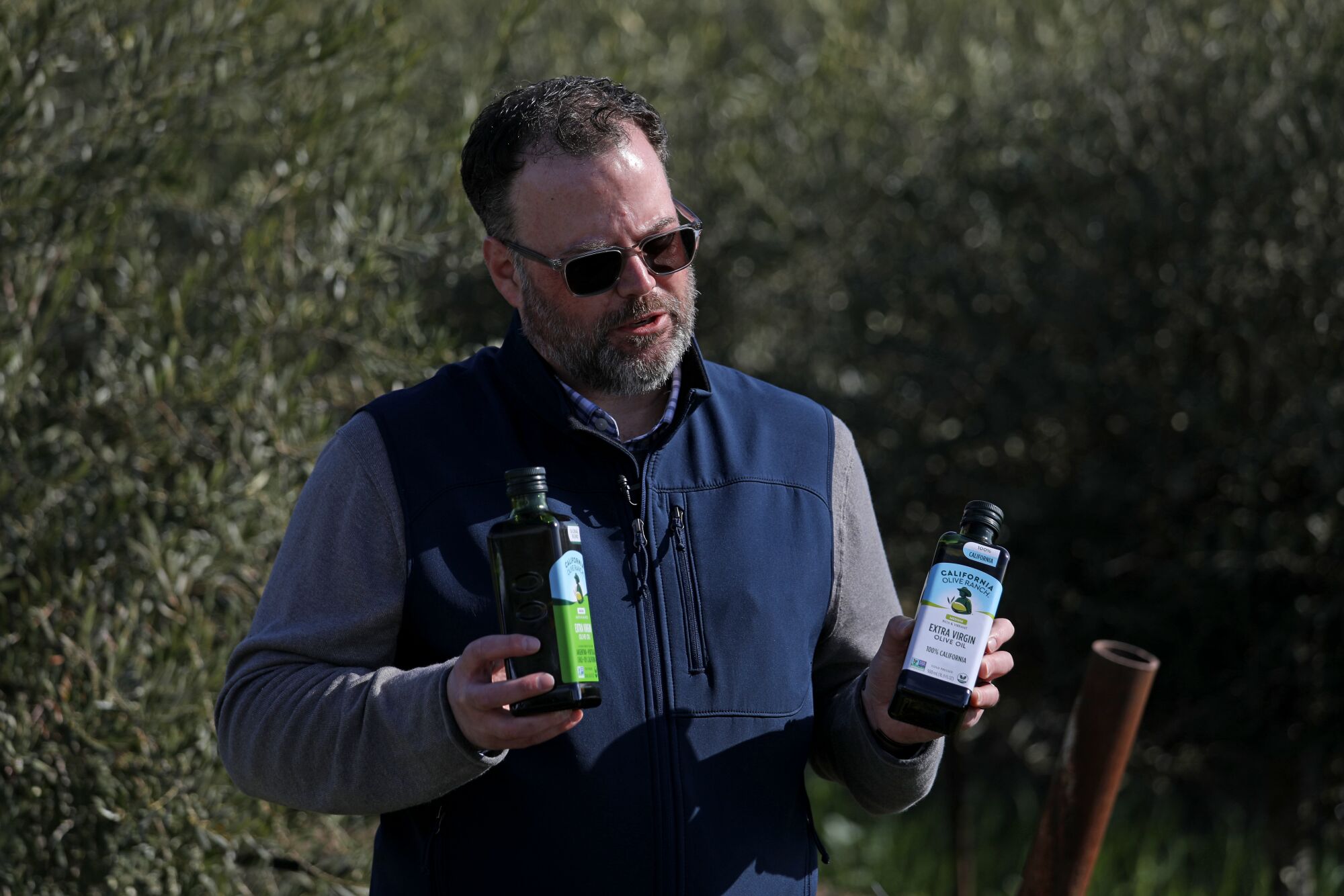 Michael Fox, chief executive of California Olive Ranch, holds bottles of the company's offerings