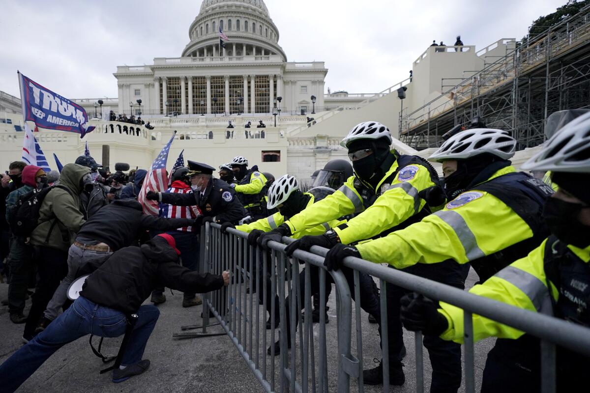Trump supporters try to break through a police barrier Jan. 6 at the Capitol.