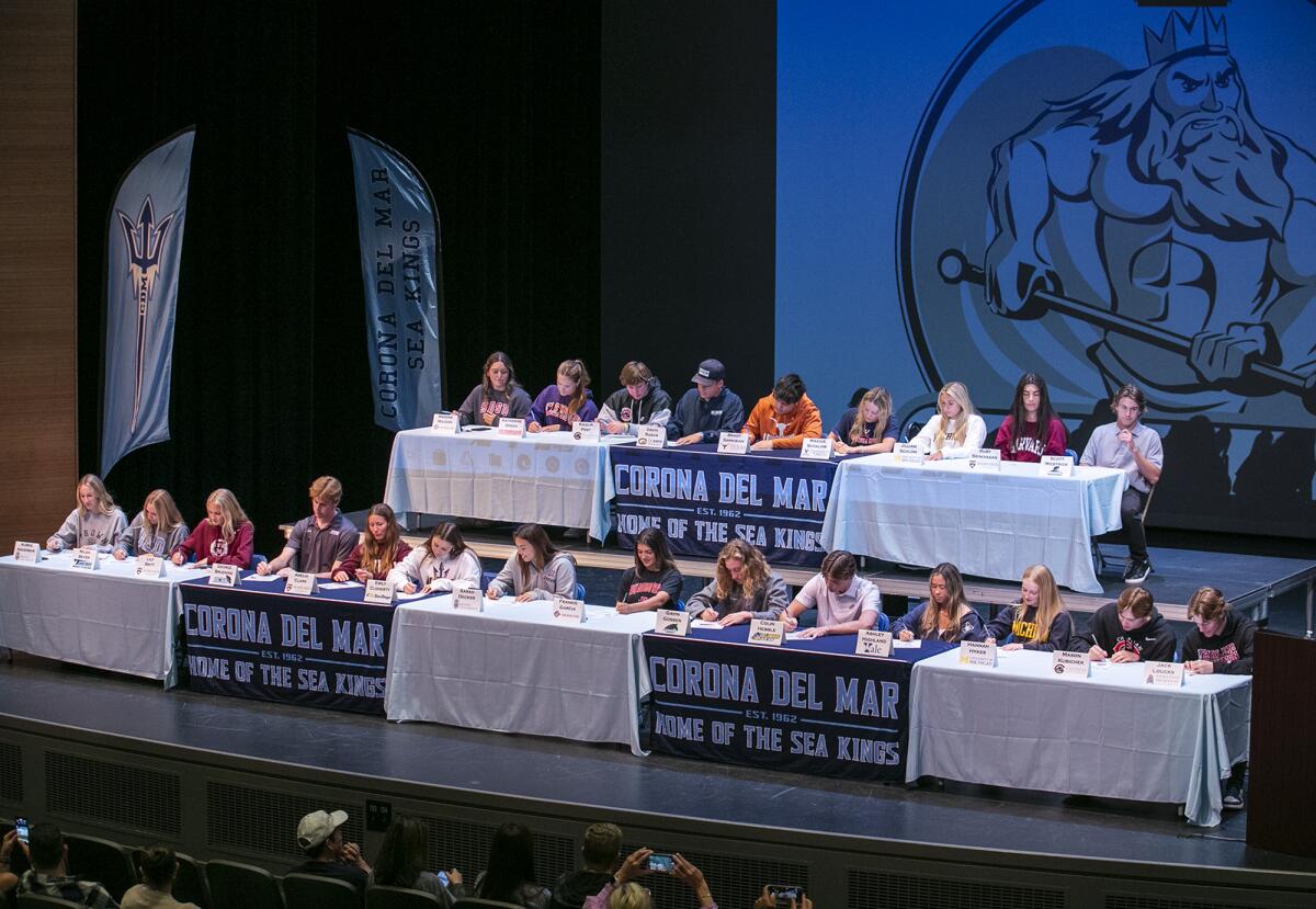 Corona del Mar High School student-athletes ceremonially sign to play a sport in college at the school on Monday.