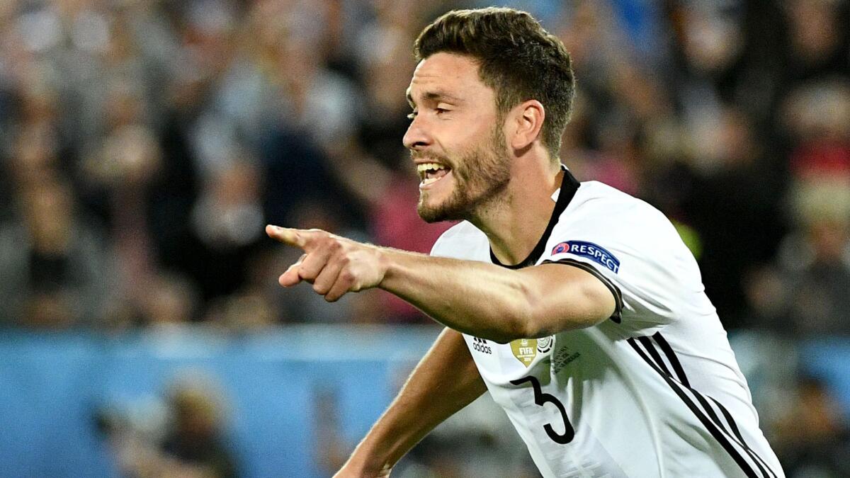 Jonas Hector begins to celebrate after scoring the decisive penalty kick in Germany's victory over Italy on Saturday.