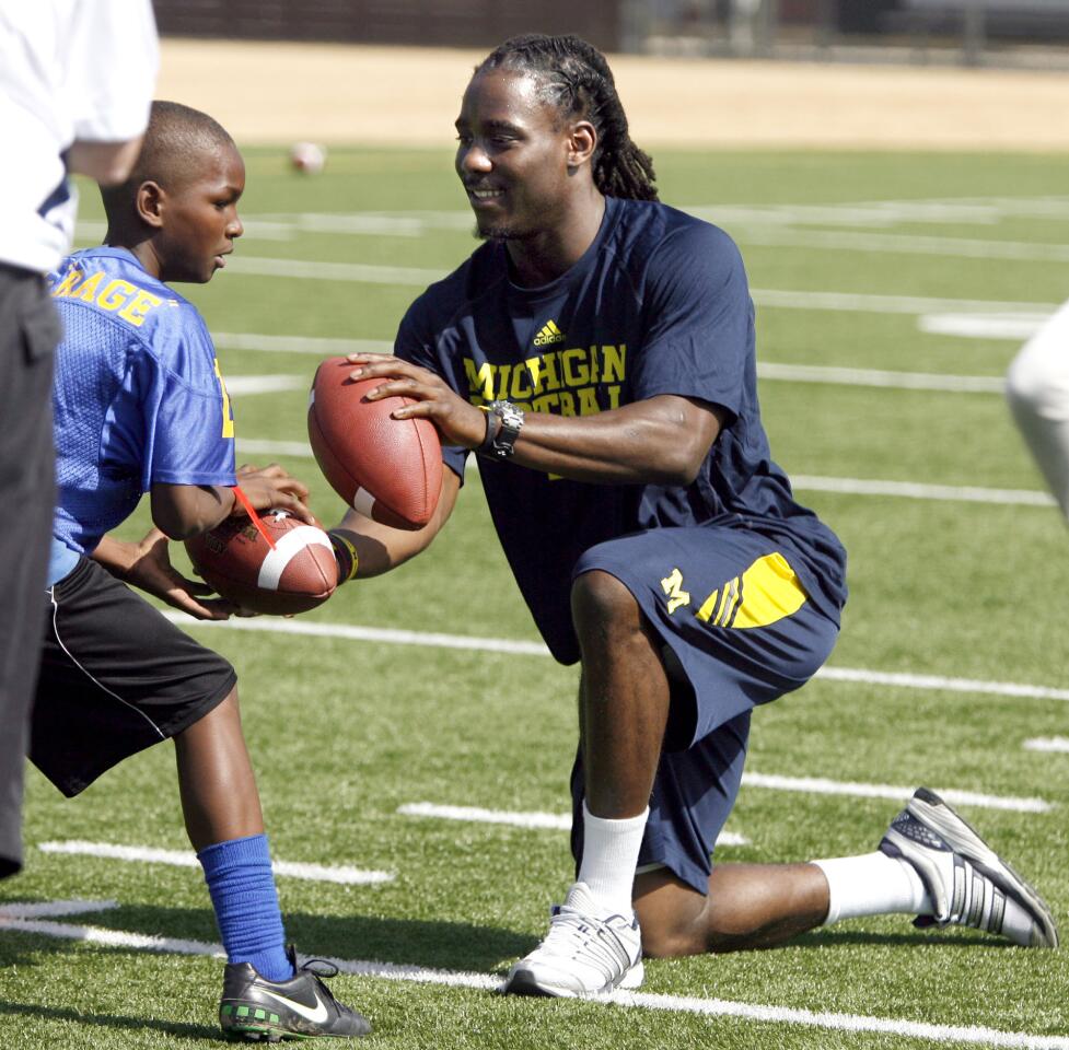 Photo Gallery: University of Michigan football players help local kids