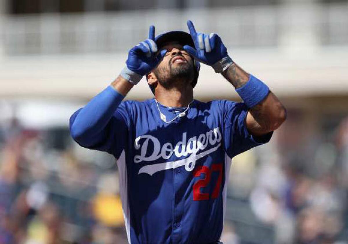 Matt Kemp points to the sky after hitting a solo home run against the Texas Rangers during a spring training game on March 9.