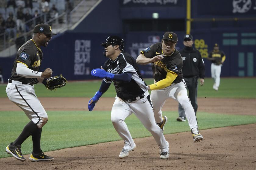 San Diego Padres' Ha-Seong Kim tags out Team Korea's Moon Bo-gyeong at rundown during the exhibition game between the Team Korea and San Diego Padres at the Gocheok Sky Dome in Seoul, South Korea, Sunday, March 17, 2024. The Los Angeles Dodgers and the San Diego Padres will meet in a two-game series on March 20th-21st in Seoul for the MLB World Tour Seoul Series. (AP Photo/Ahn Young-Joon)