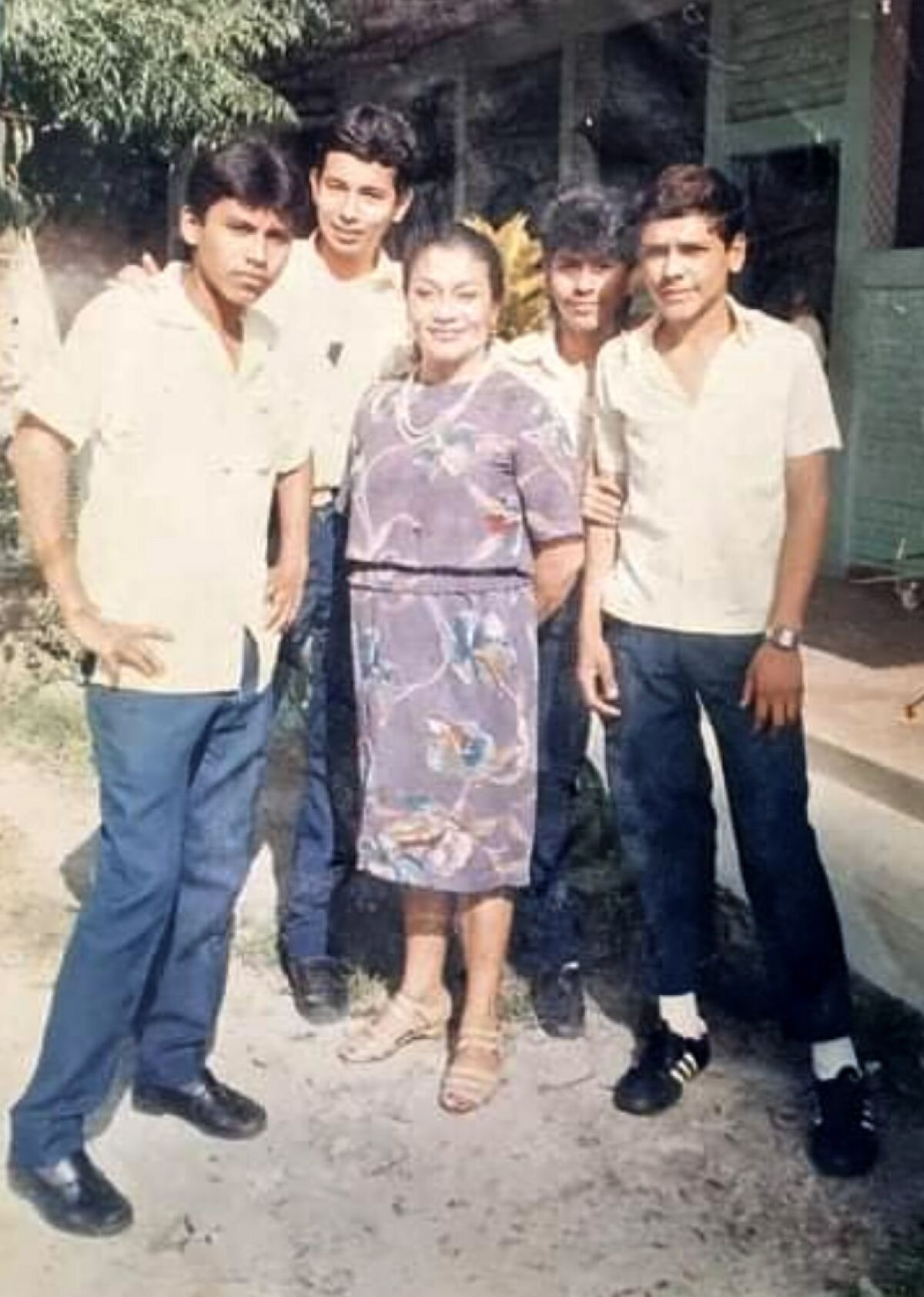Jose Tomas Mejia, pictured on the far left, after he graduated from high school in El Salvador.