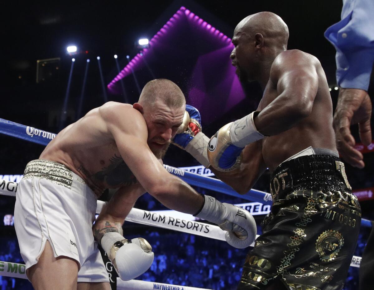 Floyd Mayweather Jr. connects to the head of Conor McGregor during their super-welterweight bout.