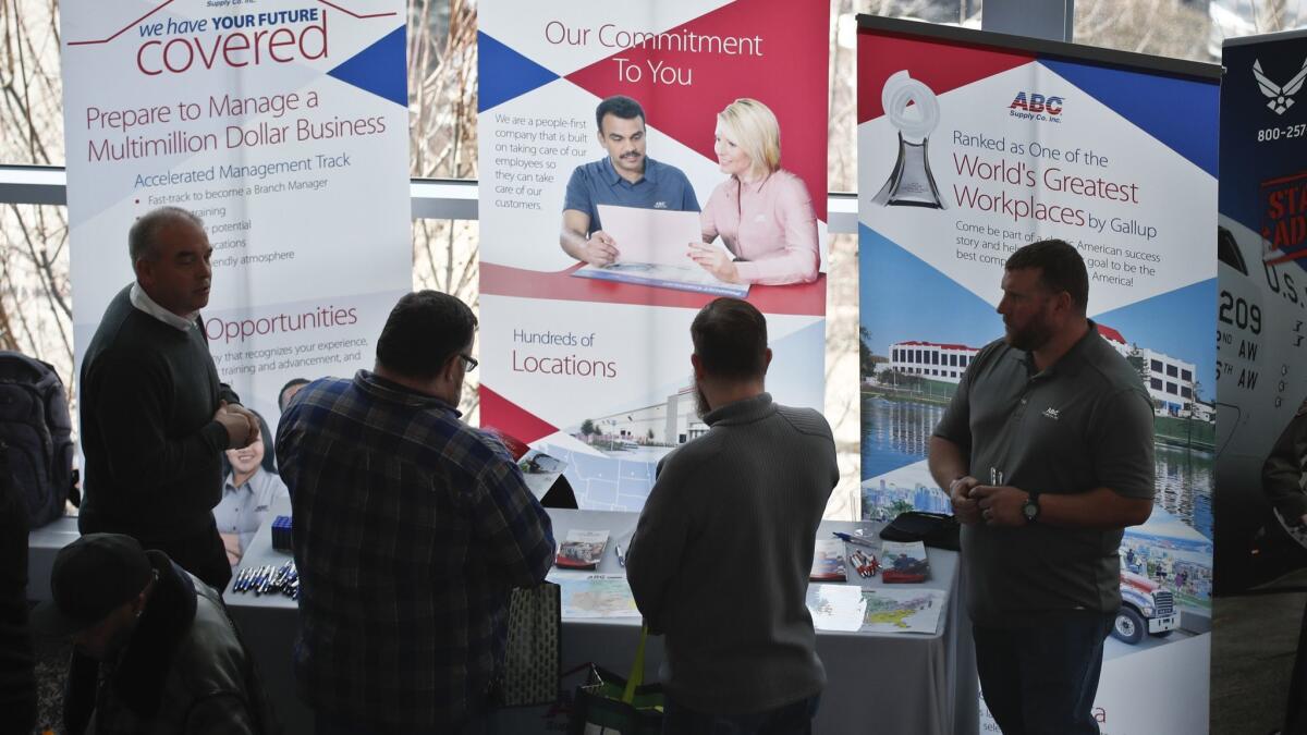 People at a veterans job fair meet with recruiters in Pittsburgh on March 7.