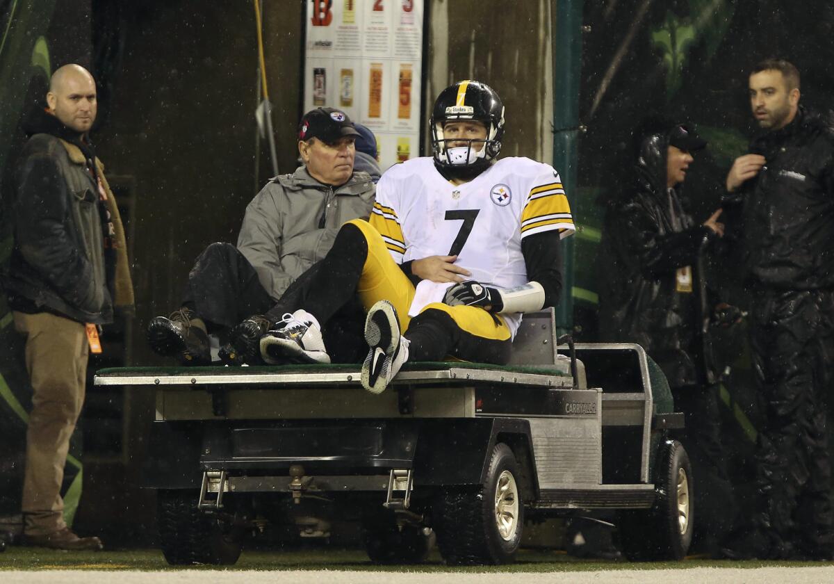 Steelers quarterback Ben Roethlisberger is taken to the locker room during the third quarter of a playoff game against the bengals.