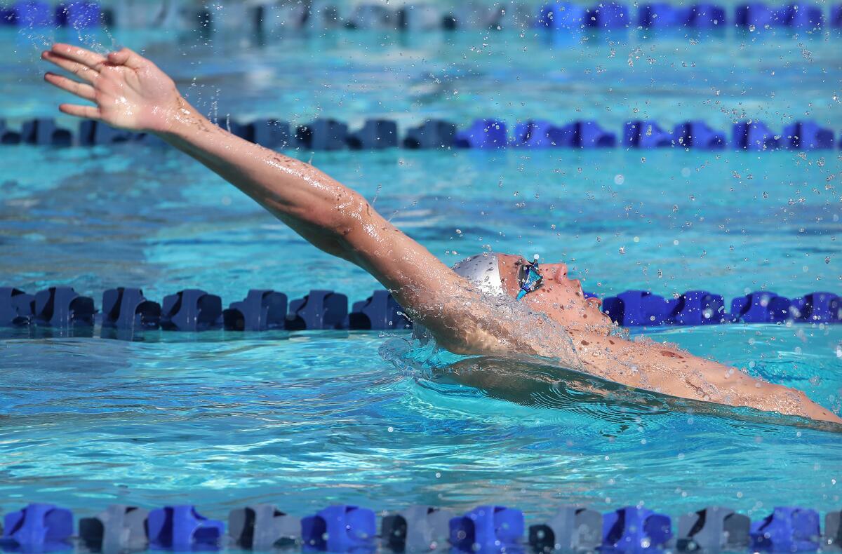 Newport Harbor's Aidan Arie swims the backstroke leg of the 200-yard medley relay. 