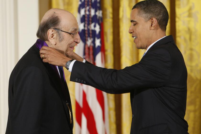 FILE - In this Thursday, Feb. 25, 2010, file photo, President Barack Obama presents a 2009 National Medal of Arts to Milton Glaser, in the East Room of the White House in Washington. Glaser, the designer who created the “I (HEART) NY” logo and the famous Bob Dylan poster with psychedelic hair, died Friday, June 26, 2020, his 91st birthday. (AP Photo/Charles Dharapak, File)
