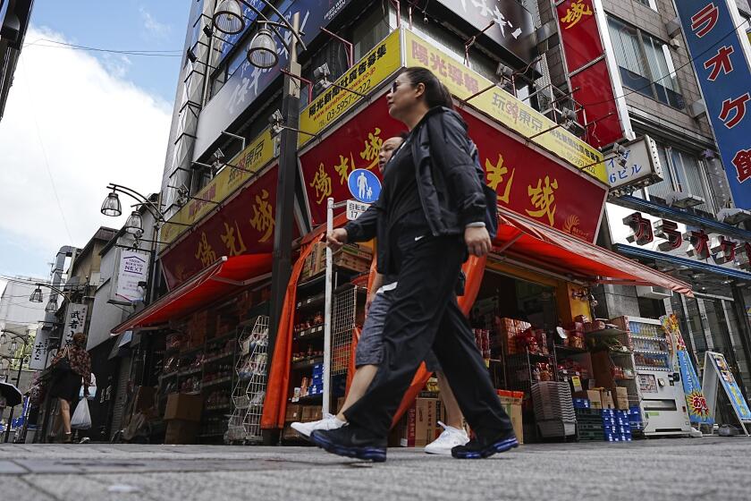 Peatones caminan frente a una tienda de comestibles de gran popularidad entre los ciudadanos chinos que viven en Japón, el miércoles 4 de septiembre de 2024, en Tokio. (AP Foto/Eugene Hoshiko)