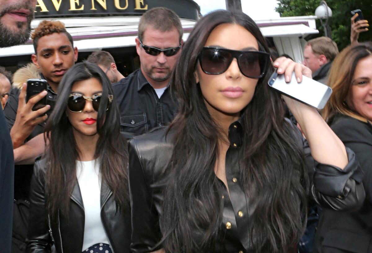 Kim Kardashian, front, meant to have fun with sisters Kourtney Kardashian, left, and Khloe Kardashian during an interview. But her comments were taken out of context, she says.