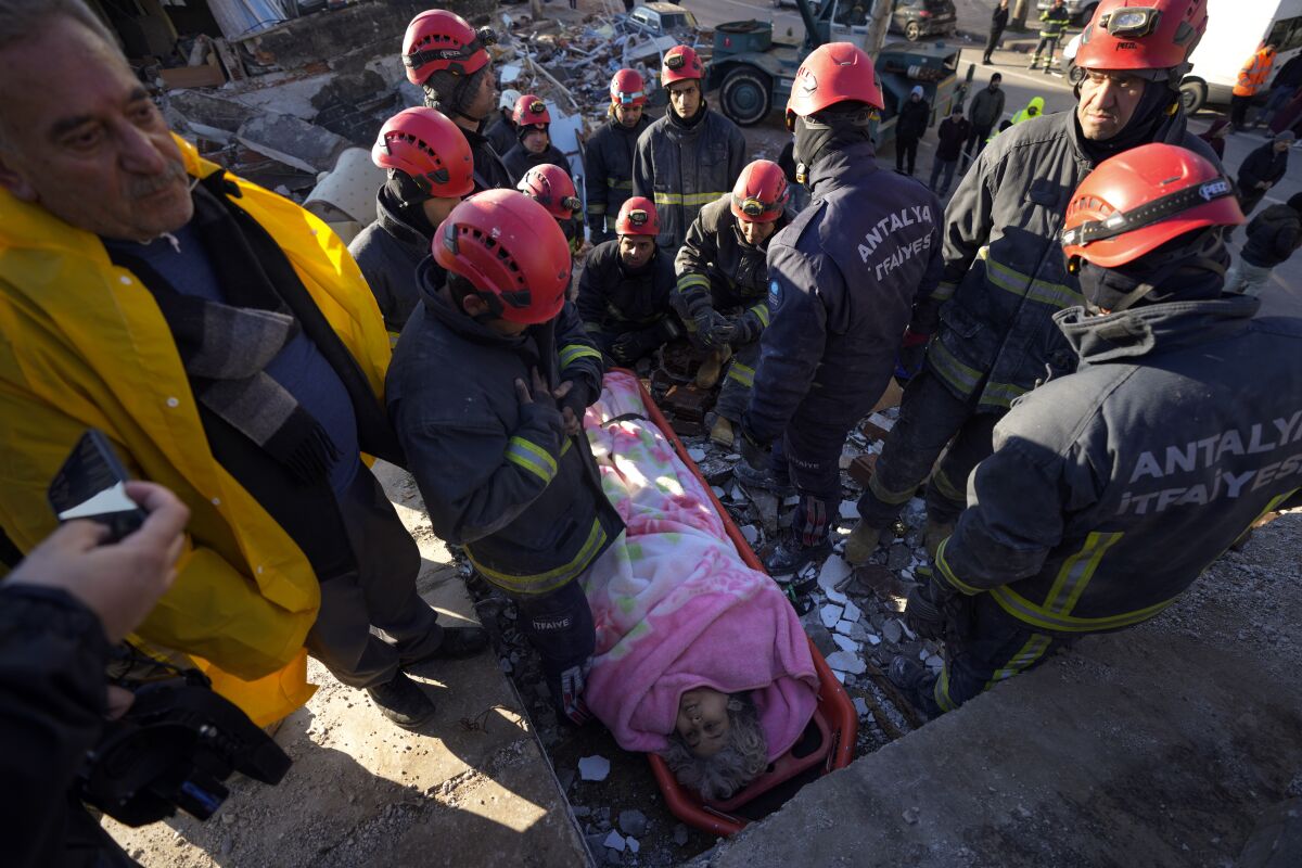 Equipos de rescate sacan a una sobreviviente de entre los escombros de un edificio destruido en Kahramanmaras, sur de Turquía, el martes 7 de febrero de 2023. (AP Foto/Khalil Hamra)