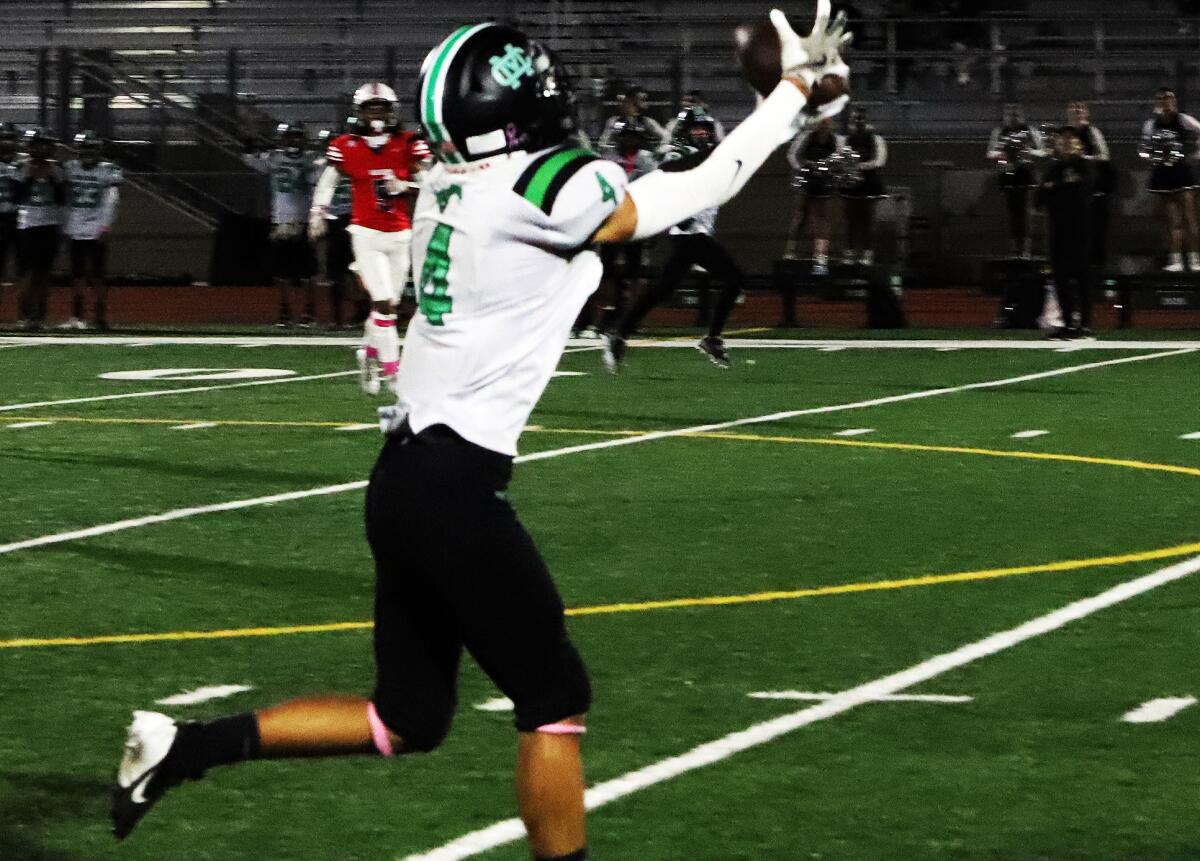 Costa Mesa's Govern Nguyen (4) makes a reception against Bolsa Grande in a Tango League football game on Thursday.