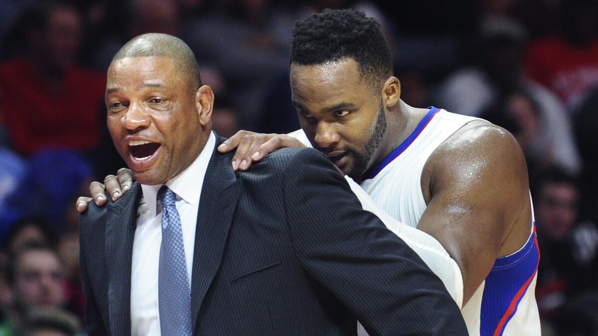 Clippers Coach Doc Rivers, left, and forward Glen Davis share a laugh during a win over the Sacramento Kings at Staples Center on Feb. 21.