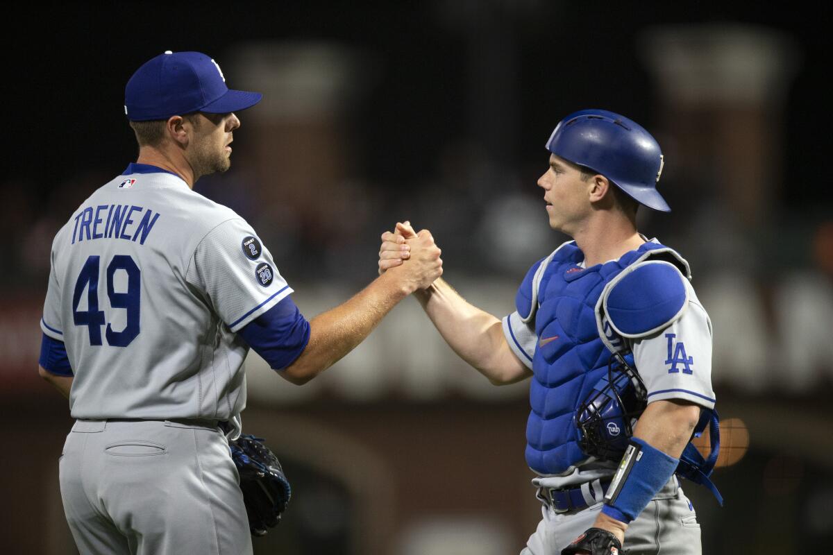Dodgers pitcher Blake Treinen, left, and catcher Will Smith celebrate a win over the Giants on May 21.