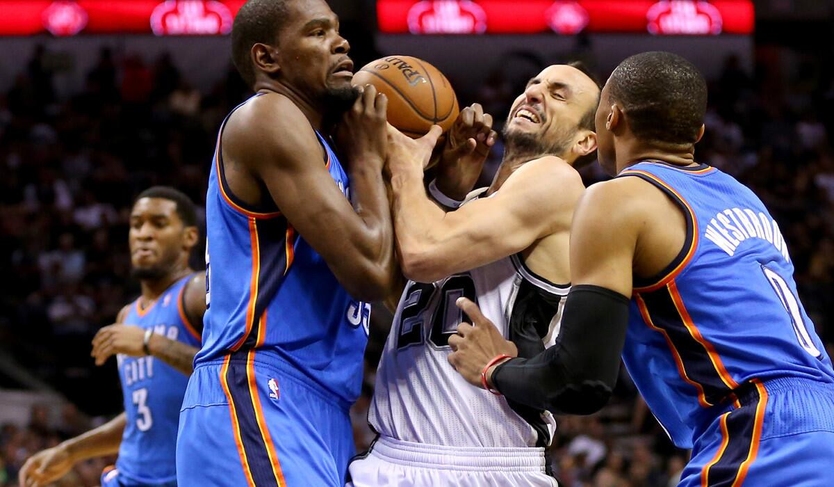 Spurs guard Manu Ginobili tries to drive between Thunder forward Kevin Durant, left, and guard Russell Westbrook in the first half Wednesday night.