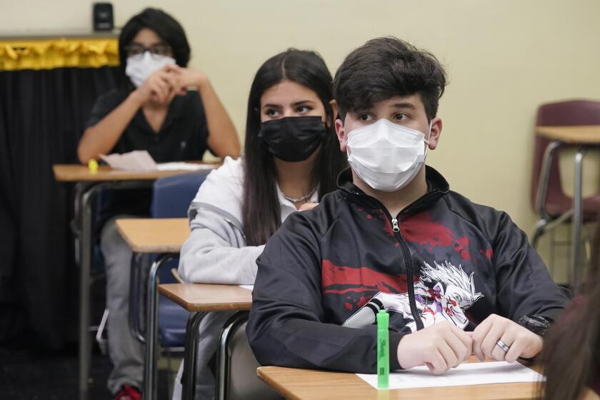 Students sit in an Algebra class at Barbara Coleman Senior High School on the first day of school, Monday, Aug. 23, 2021, in Miami Lakes, Fla. Miami-Dade County public schools require students to wear a mask to prevent the spread of COVID-19. (AP Photo/Marta Lavandier)