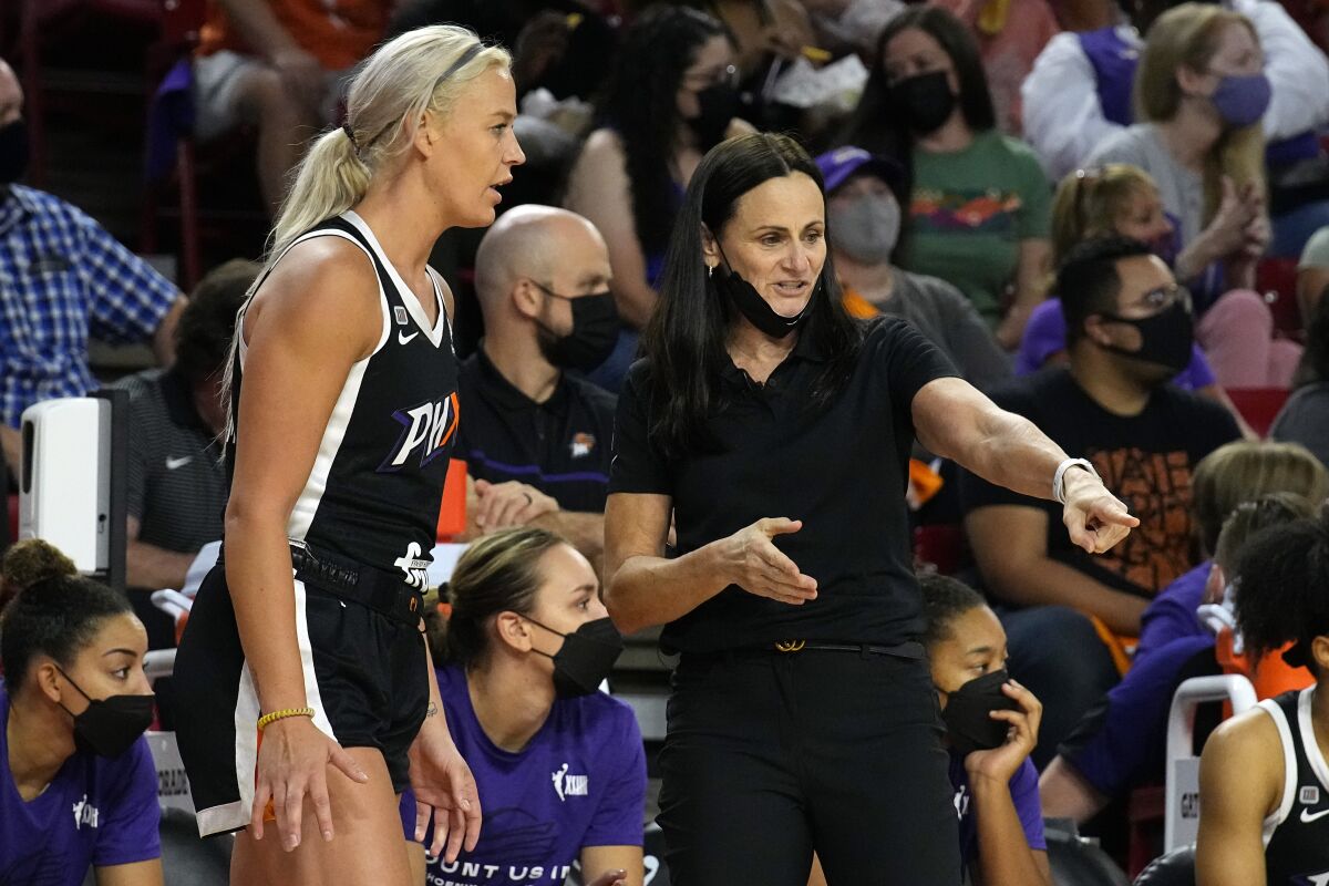 Phoenix Mercury guard Sophie Cunningham (9) talks to head coach Sandy Brondello during the first half of a WNBA basketball game against the Las Vegas Aces, Sunday, Oct. 3, 2021, in Phoenix. (AP Photo/Rick Scuteri)