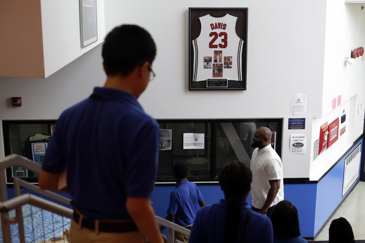 Tiray Jackson of Perspectives Charter Schools stands under the Anthony Davis's jersey.