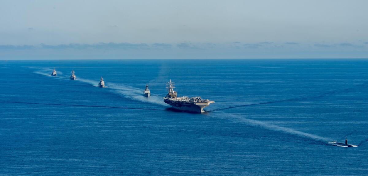 In this photo provided by the South Korea Defense Ministry, the USS Ronald Reagan aircraft carrier, second from right, participates in a joint anti-submarine drill among South Korea, the United States and Japan in waters off South Korea's eastern coast in South Korea, Friday, Sept. 30, 2022. South Korea, U.S. and Japanese warships launched their first trilateral anti-submarine drills in five years on Friday, after North Korea renewed missile tests this week in an apparent response to bilateral training by South Korean and U.S. forces. (South Korea Defense Ministry via AP)