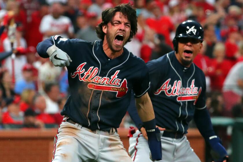ST. LOUIS, MO - OCTOBER 06: Dansby Swanson #7 and Rafael Ortega #18 celebrate after scoring on a single from Adam Duvall #23 of the Atlanta Braves in the top of the ninth inning to give them the lead 3-1 against the St. Louis Cardinals during Game 3 of the NLDS between the Atlanta Braves and the St. Louis Cardinals at Busch Stadium on Sunday, October 6, 2019 in St. Louis, Missouri. (Photo by Dilip Vishwanat/MLB Photos via Getty Images)