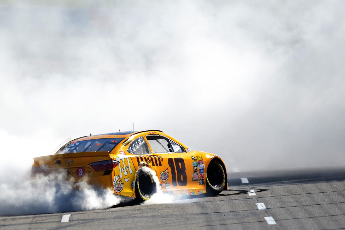 Kyle Busch celebrates with a burnout after winning the NASCAR Sprint Cup Series STP 500 at Martinsville Speedway on April 3.