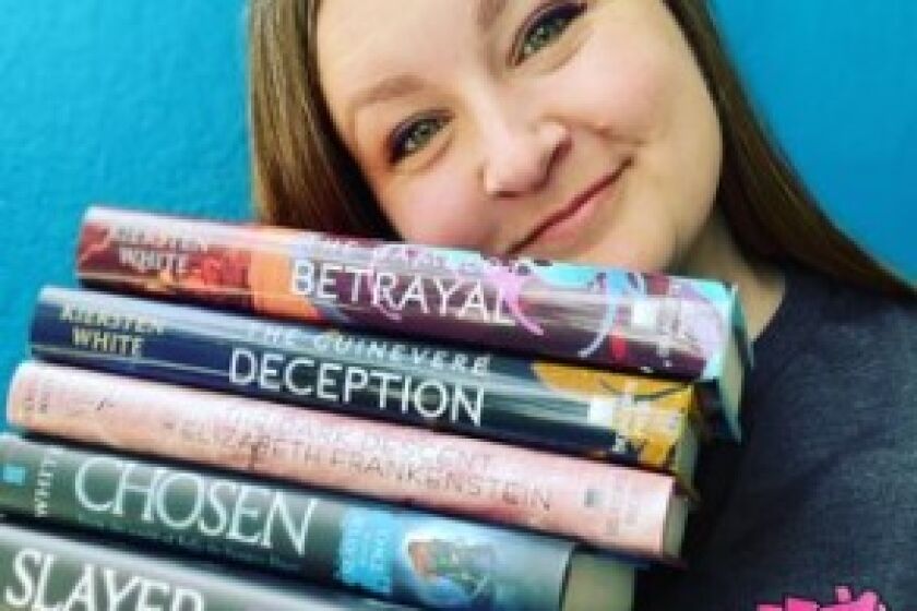 Kiersten White holds a few of her young adult fantasy novels. She is writing about Obi-Wan for the "Star Wars" franchise.