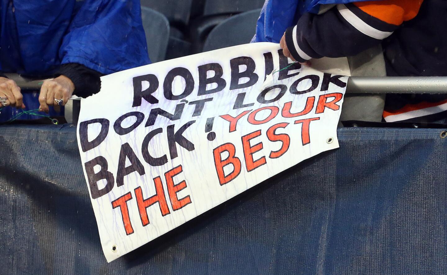Bears fans pack up their Robbie Gould sign after the kicker missed a field goal in the 24-21 loss.