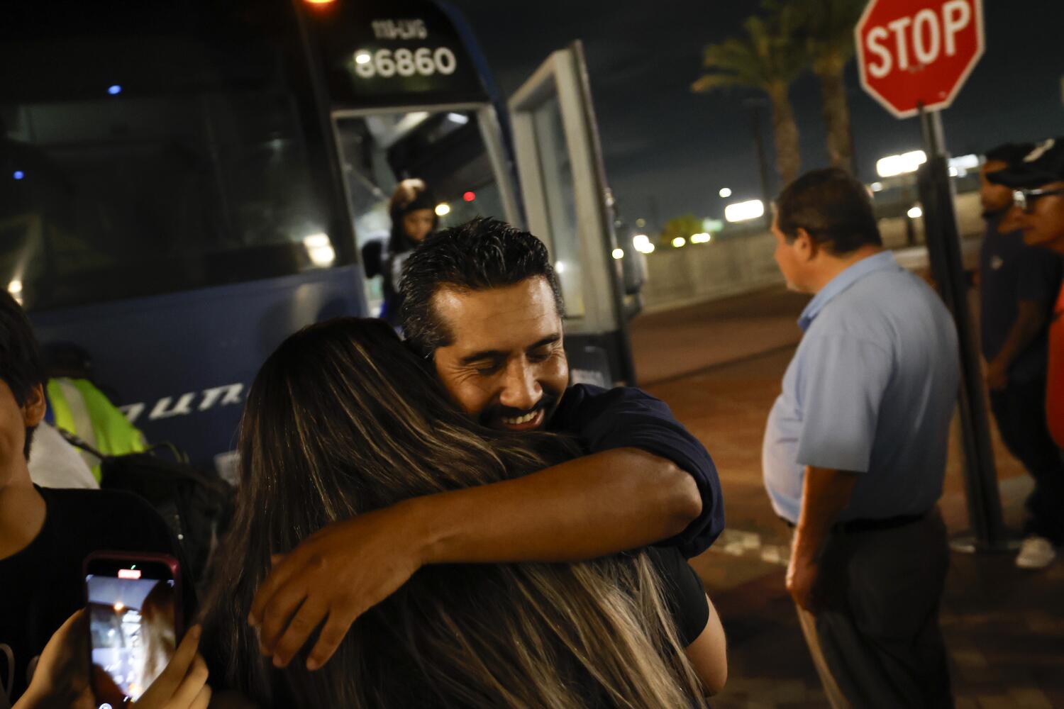 Los Angeles, CA - September 18: Angel Rodrigo Minguela Palacios hugs his wife after arriving at Union Station in a Greyhound bus from Phoenix, Ariz. after being released from an Ariz. detention center on Thursday, Sept. 18, 2025 in Los Angeles, CA. (Carlin Stiehl / Los Angeles Times)