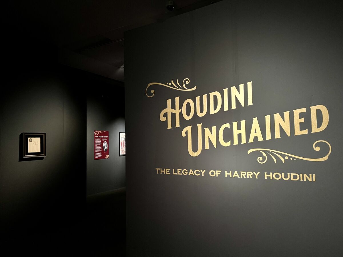 A sign that reads "Houdini Unchained: The Legacy of Harry Houdini."