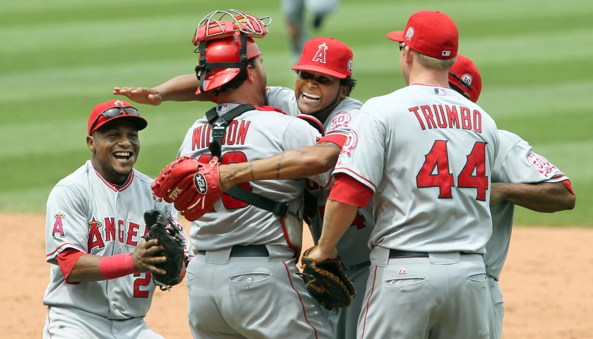 Angels pitcher Ervin Santana hugs catcher Bobby Wilson and celebrates with teammates after throwing a no-hitter.
