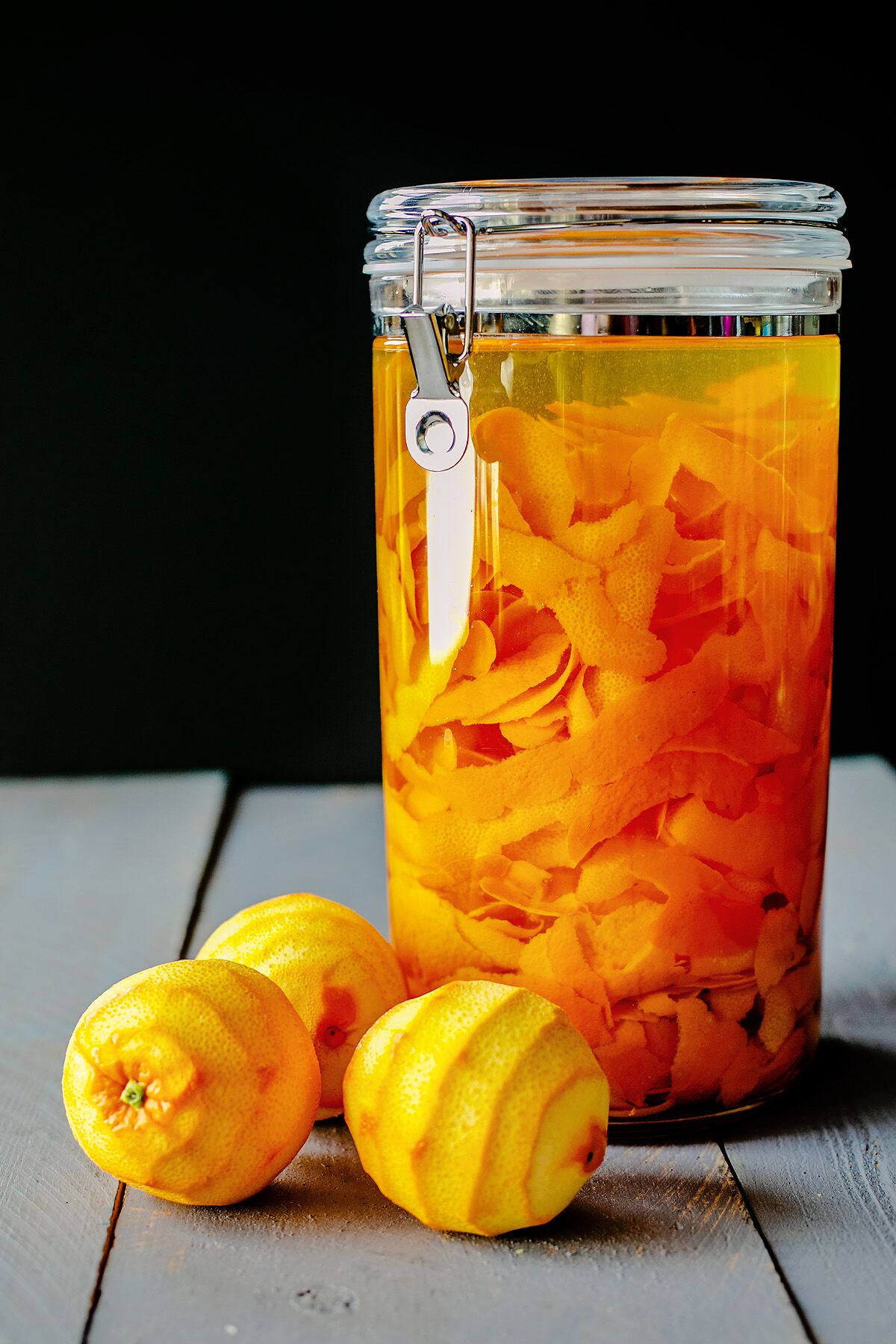 A container filled with orange peels and vodka.