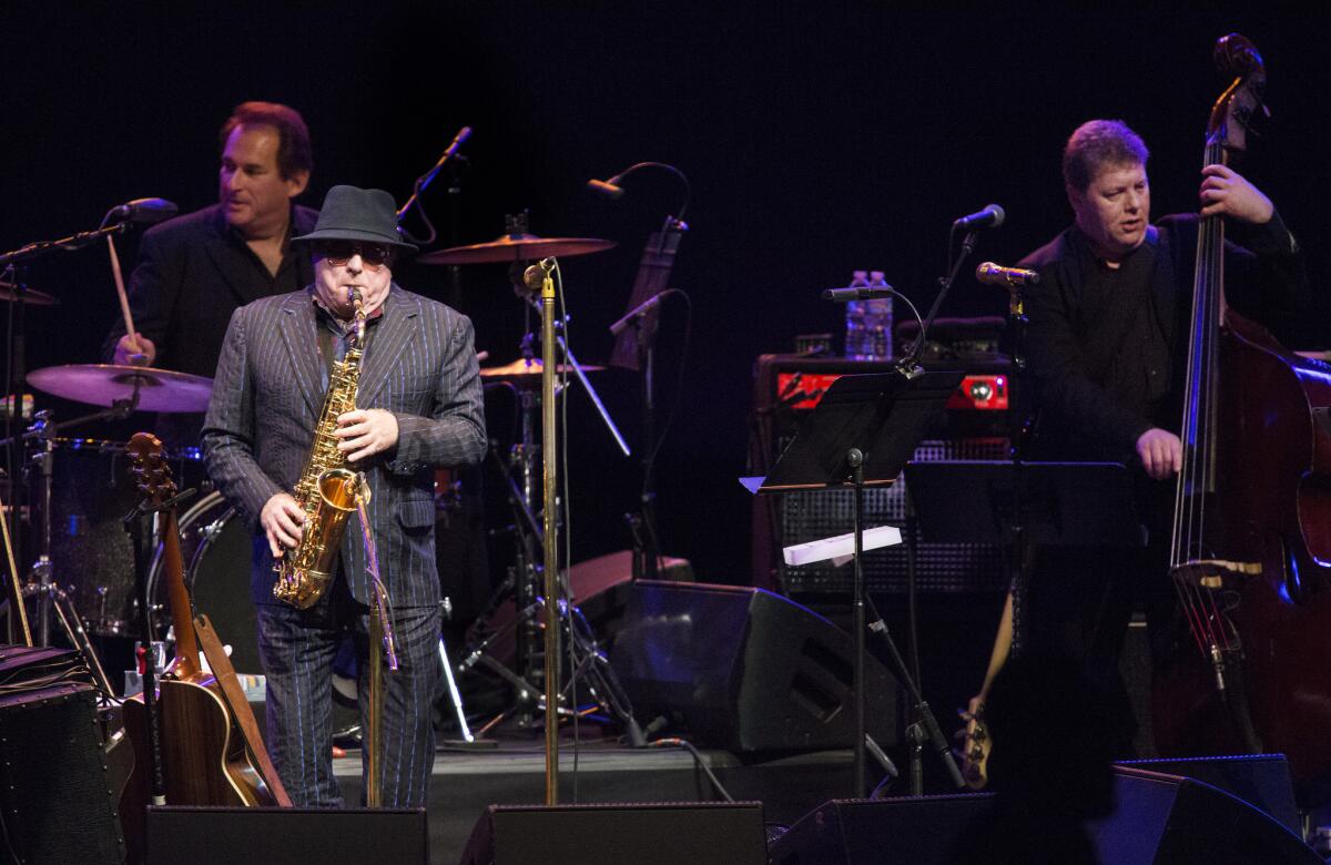 Van Morrison plays saxophone during his Friday concert at the Shrine Auditorium.