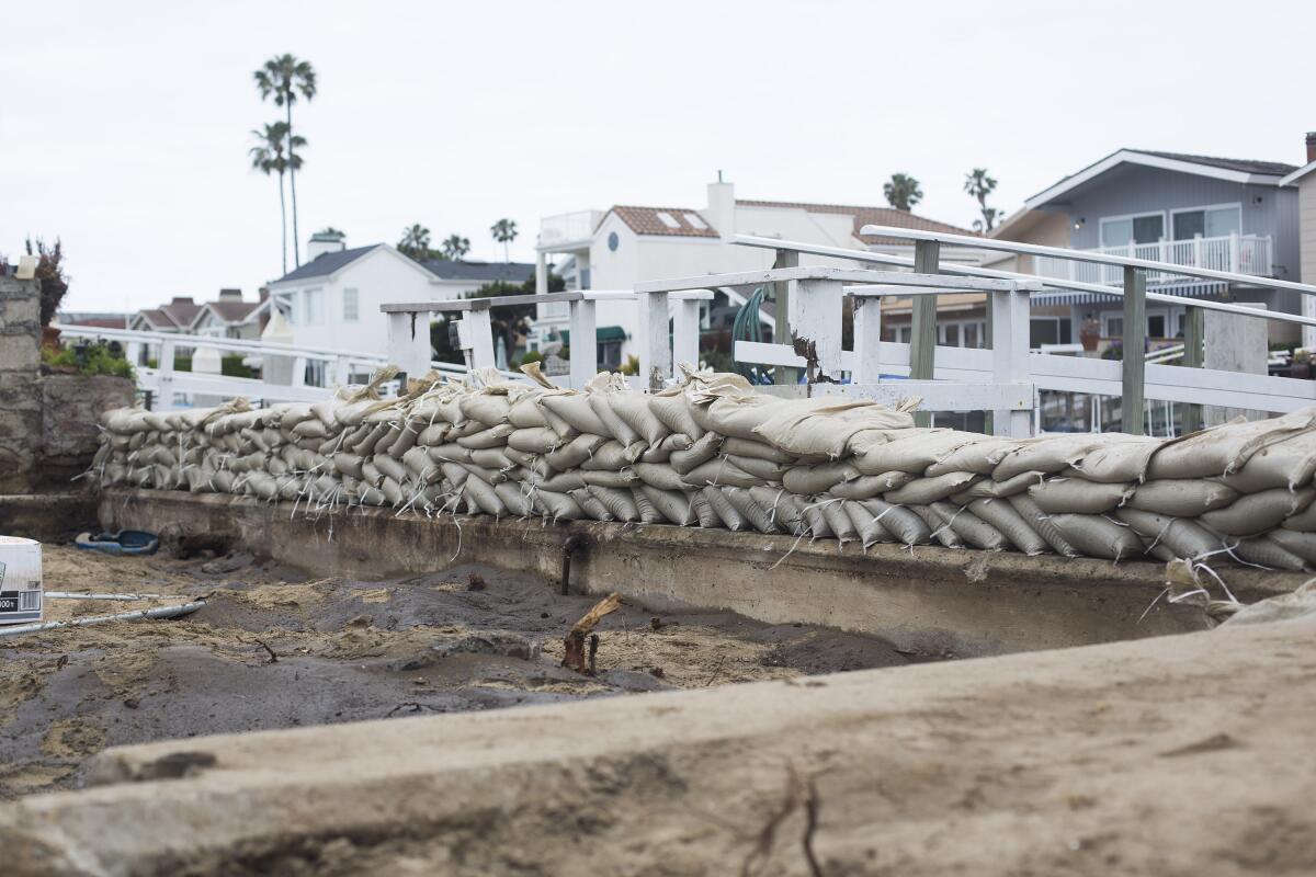 A temporary seawall to prevent flooding during high tide in Newport Beach.