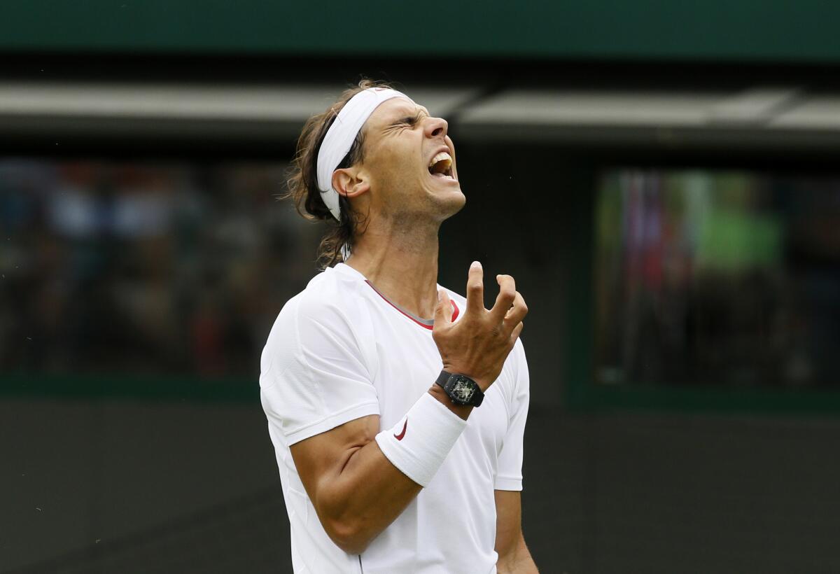 Rafael Nadal reacts as he loses a point to Steve Darcis of Belgium during their men's first-round singles match at Wimbledon.
