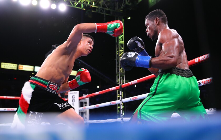 Jaime Munguia, left, throws a punch at Patrick Allotey.
