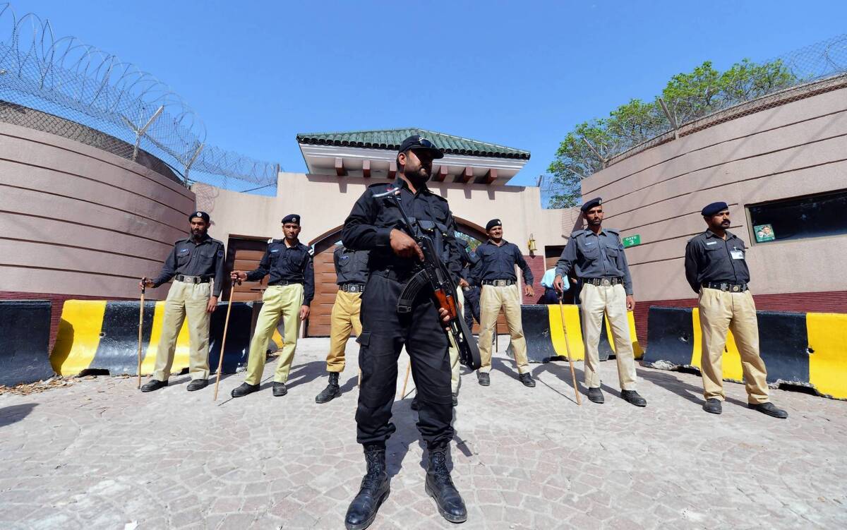 Pakistani police stand guard outside the villa of former President Pervez Musharraf on the edge of Islamabad.