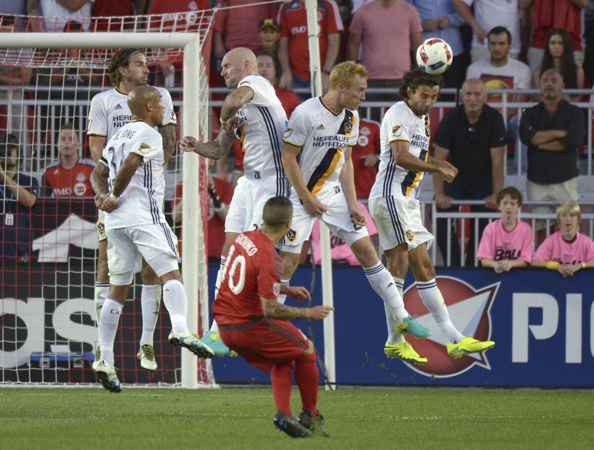 The Galaxy wasll tries to block a free kick by Toronto FC's Sebastian Giovinco during the second half of an MLS match on June 18.