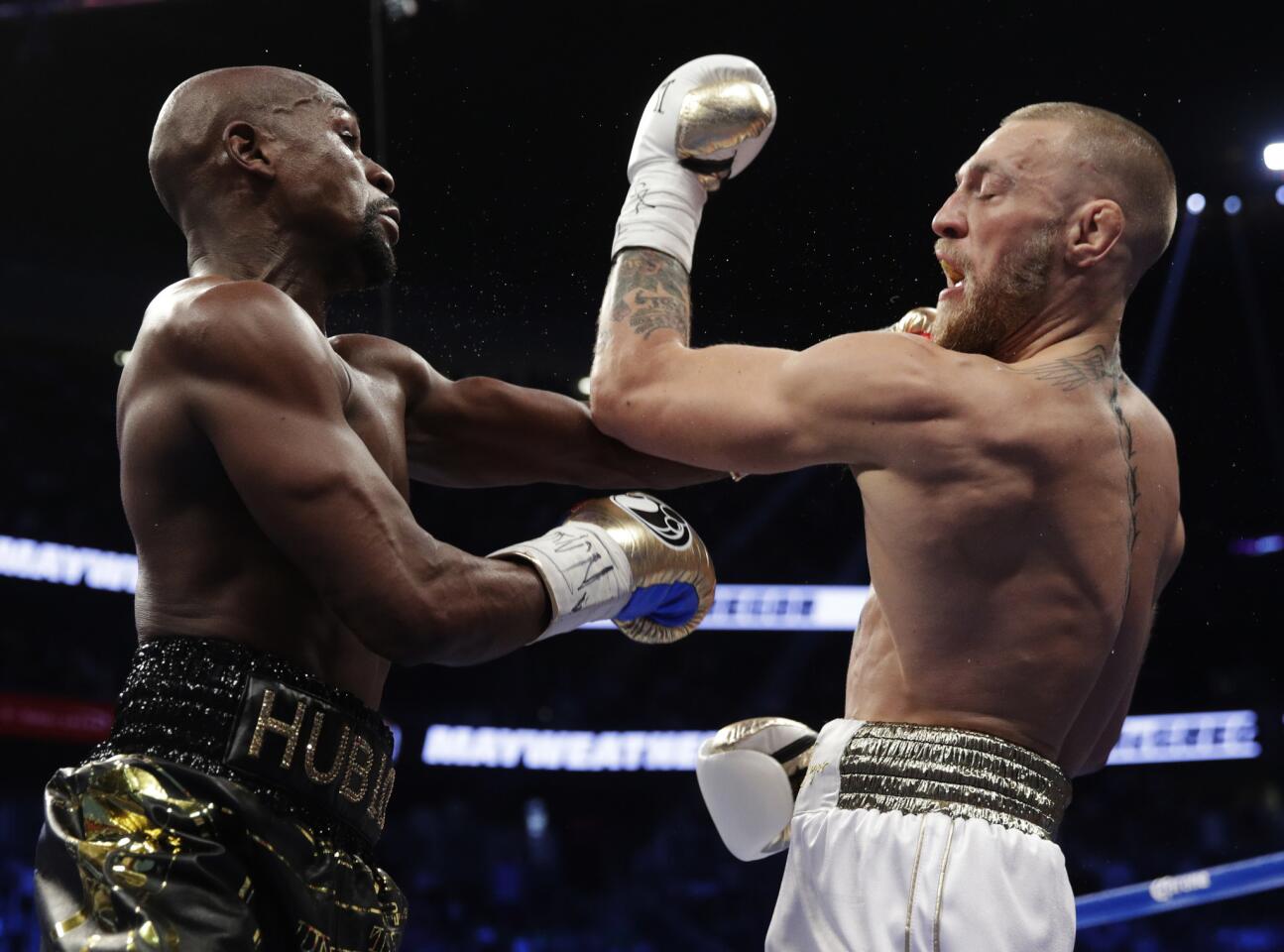 Floyd Mayweather Jr. connects with a left against Conor McGregor during their super-welterweight bout.