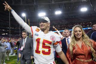 Kansas City Chiefs quarterback Patrick Mahomes (15) leaves the field with his wife Brittany