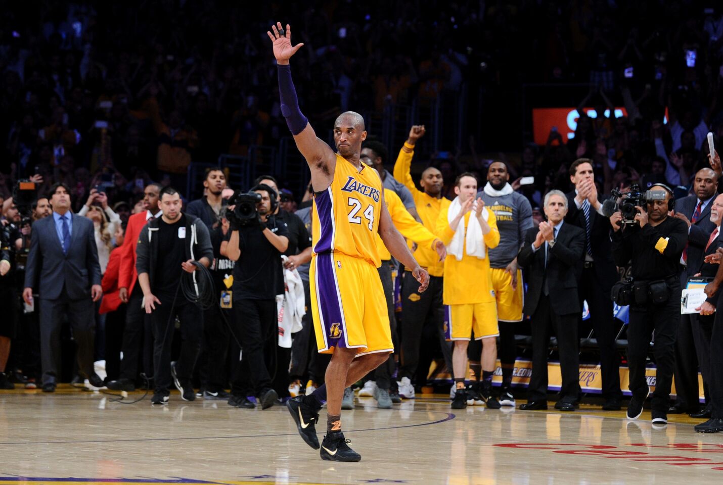 Kobe Bryant waves to the crowd as he walks off the court for the last time at Staples Center.
