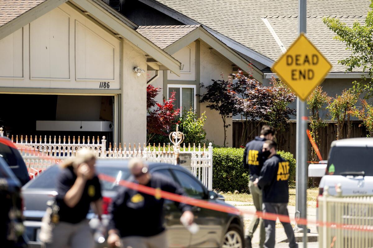 Federal agents outside a house