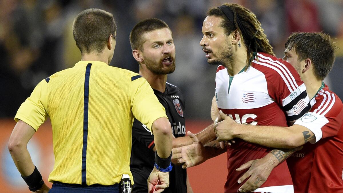 Revolution midfielder Jermaine Jones is restrained by teammate Kelyn Rowe and D.C. United midfielder Perry Kitchen after he was given a red card and ejected during the second half on Oct. 28, 2015.