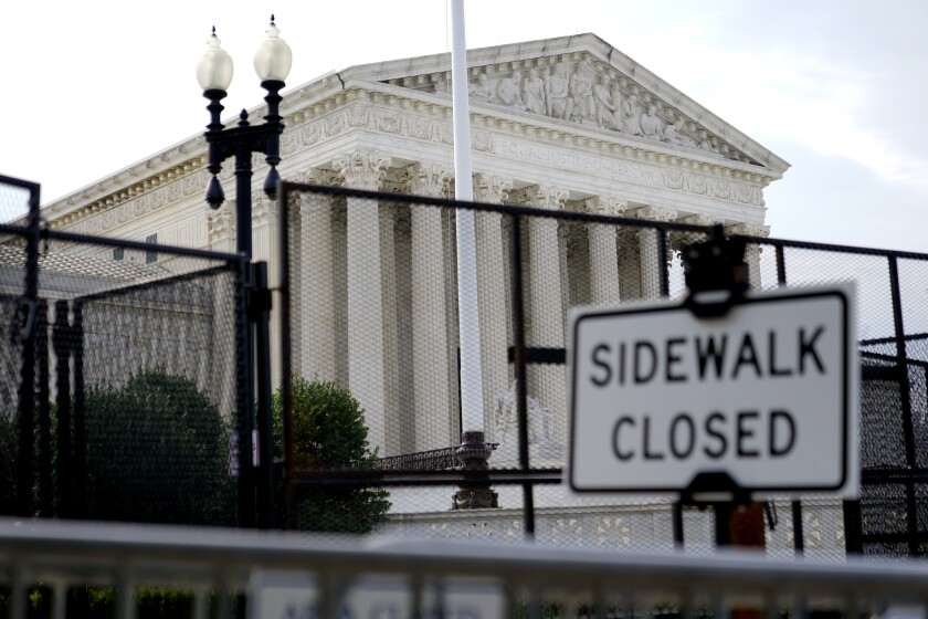 Security fencing surrounds the U.S. Supreme Court building, Monday, June 27, 2022, in Washington. (AP Photo/Patrick Semansky)