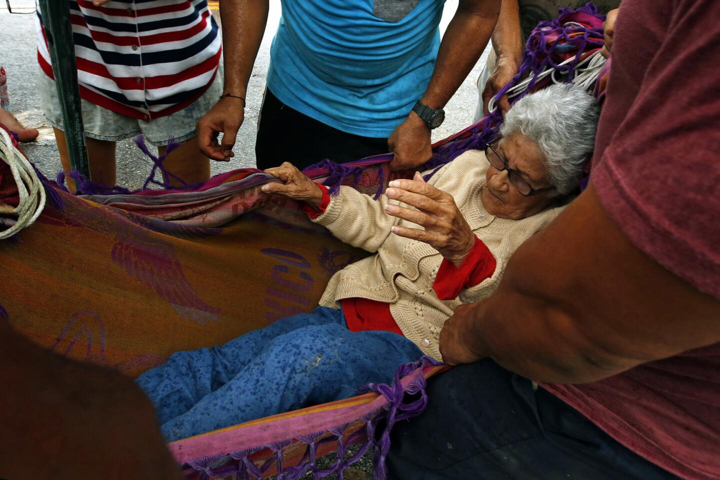 Delia Pineda, 89, is evacuated from Salto Arriba, an area cut off from Utuado following Hurricane Maria.